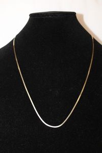 lot 473 image: 14K yellow gold Serpentine necklace. Marked 14K. 23L