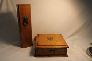 lot 317 image: Victorian Edwardian English solid oak shield emblem cigar keeper with key 8.5W x 8.5D X 3.25H and Solid Oak Fireplace Match Box with Brass Hardware and Lion Head Detail - Wall Mountable, brass match striker on reverse. New box of matches included.
