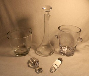 lot 311 image: Barware. Includes (2) Ice buckets, decanter stoppers and a crystal decanter. (1) is a Vera Wang for FTD Ice Bucket. 7.5H
