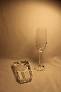 lot 309 image: High End quality Crystal Cigar ash receiver 6.25L x 4W x 1H & 75th Anniversary Zippo crystal champagne flute. 10H