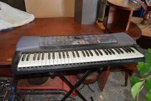 lot 198 image: Casio Electric Keyboard with Light-Up Keys PLUS Stand