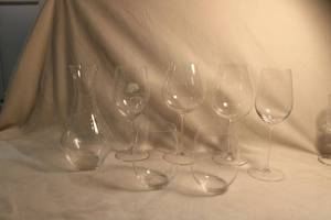 lot 305 image: Riedel crystal collection. Includes a RIEDEL Vivant Series Clear Crystal Balloon Wine Decanter 36oz capacity and assorted stemmed and stemless wine glasses. Two stemless glasses have the Acura logo on bottom also. All marked Riedel. 7 count.