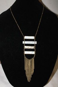 lot 374 image: Signed mid century horizontal Howlite bar tassel necklace. Necklace 32L, full length with tassels is 46L. Tassel drop is 3.5. Has oval jewelry hang tag W