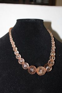 lot 375 image: Vintage Lucite  Acrylic faceted and ribbed graduated bead necklace. Features a muted pink color palette. 16L w 2 Extender. Lobster clasp.