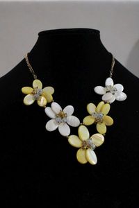 lot 376 image: Vintage 1950s pearlized glass petal flower necklace in DAISY form with iridescent and gold accent beads on a gold tone chain. 16L w a 2 extender chain. Lobster clasp.