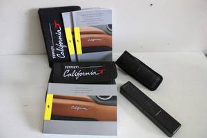lot 297 image: Ferrari Owners Manual, Warranty and Reference Books for a 2015, Porsche Tool Pack, and a Mace Holder