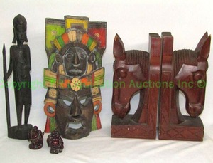 lot 67 image: Solid wood horse head book ends made in Viet Nam, Central American face mask art, and ebony stained wood statue