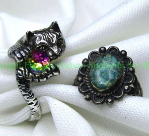 lot 154 image: (2) Sterling silver rings. Figural cat ring with faceted glass ball (Size 9) and a reconstituted micro Turquoise ring (Size 6.5). Ring has slightly misshapen band. Both marked 925.