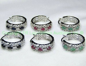 lot 155 image: (3) Sterling silver and gemstone post hoop earrings. Emerald, Sapphire and Ruby. All tested. All marked 925. Approx 3.00 cttw per pair (3-.50 ctw ovals per earring)