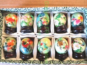 lot 225 image: Soap stone hand painted mini egg set with lacquered wood pedestal, each approx. 1.5 tall