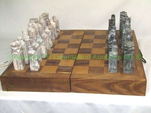 lot 43 image: Solid marble chess set with wood storage board (One piece is broken in half)