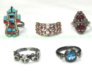 lot 315 image: (5) Sterling silver rings. TurquoiseCoral medicine man (size 7, unmarked), Blue Topaz (Size 5.5), Marcasite & Garnet (Size 7), Vermeil and white quartz (Size 7.5) and figural wolf pup ring (size 8). All 4 are marked 925 or sterling