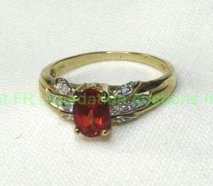 lot 319 image: 10K yellow gold Rhodolite Garnet and Diamond ring. Marked 10K. Size 7