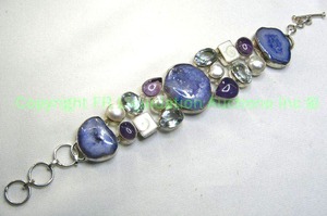 lot 325 image: Sterling silver blue sliced Geode and multi gemstone bracelet. Toggle clasp. 8.5L Marked 925. Includes Swiss Blue Topaz, Amethyst, Blister Pearl and Siva Shell