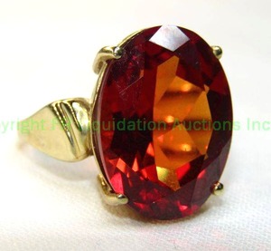 lot 19 image: 10K yellow gold and Orange Sapphire ring. Marked 10K. Size 8