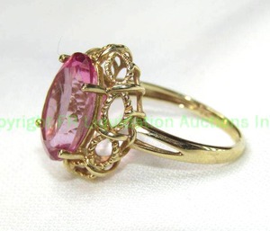 lot 23 image: 10K yellow gold and Pink Sapphire ring. Marked 10K. Size 7