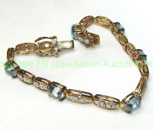 lot 91 image: Sterling silver vermeil Topaz cabochon station bracelet. Marked 925. 8L  Approx 7 cttw. Hidden catch with 2 safety clasps.