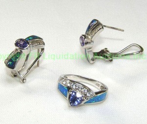 lot 92 image: Sterling silver Tanzanite, Opal and Topaz demi parure set. Includes a ring (Size 7.25) and post lever back earrings. All marked 925. Ring features a trillion cut Tanzanite and earrings have oval cabochons.