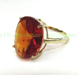 lot 94 image: 10K yellow gold and Orange Sapphire ring. Marked 10K. Size 7