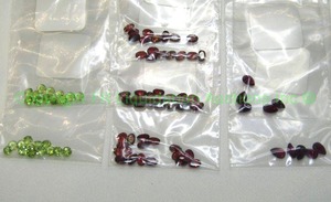 lot 131 image: (7) Gemstone parcels. Includes Red Zircon, Rhodolite and Peridot