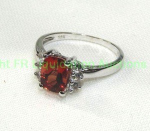 lot 134 image: 10K white gold Spessartine Garnet and white Topaz ring. Marked 10K. Size 7.25