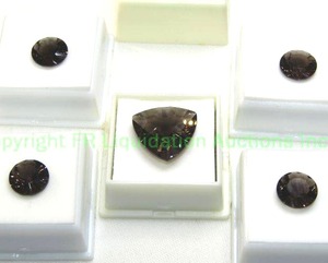 lot 138 image: (5) Smoky Quartz gemstones. (4) rounds 3.85 carat each and (1) 16.00 carat 20x20mm