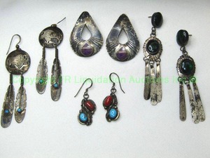 lot 335 image: (4) Sterling silver earrings. Includes a signed sterling and purple Charoite (Probably silversmith Donald Douglas). Marked sterling DD and a Turquoise and coral (Likely, Ben Yazzie. Marked Sterling BY) plus