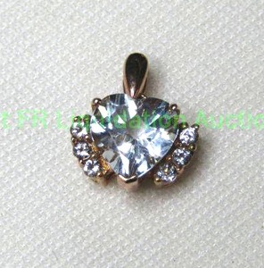 lot 354 image: 10K Rose gold Aquamarine pendant in heart form. Marked 10K Aquamarine tested.