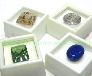 lot 386 image: (4) Gemstones. Includes Emerald cut treated Topaz 23.00 carat, Oval Lapis 15.30 carat, (2) Dendritic Quartz