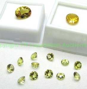 lot 388 image: (2) Heliodor gemstones. Includes 2.70 carat 12x10mm oval, 4.60 carat 14x10mm oval and (12) .60 carat 6mm rounds