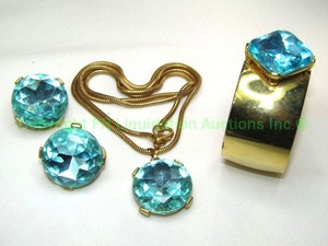 lot 424 image: Vintage Aqua foil backed faceted glass jewelry suite. Includes open cuff bracelet, clip earrings and matching pendant on  30 chain. No markings.