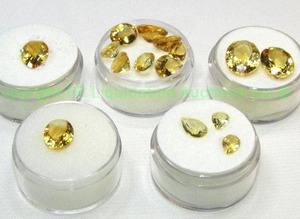 lot 404 image: (5) Yellow  Orange gemstones. Varying sizes and quantities.