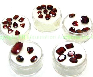 lot 410 image: (5) Red gemstones. Varying sizes and quantities.