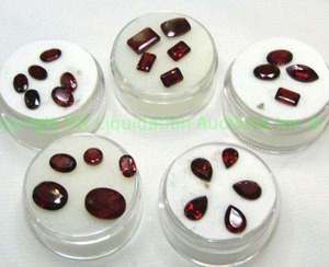 lot 411 image: (5) Red gemstones. Varying sizes and quantities.