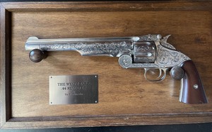 lot 23 image: Wyatt Earp .44 Revolver made by the Franklin Mint.  A 6 shot revolver that is engraved. Matching serial number to original gun SN# 20029  Comes with hardwood display & plaque, GUN IS 13 12 IN length IThis is a non-shooting replica.