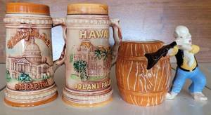 lot 94 image: (2) HAWAIIANA STEIN MUGS (1974, 1976)  AND  FIGURAL MUG WITH FIGURAL BEARDED HILLBILLY HANDLE (1950)