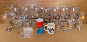 lot 154 image: HARD ROCK CAFE COLLECTION. PILSNER BEER GLASSES, MUGS, SHOT GLASSES, PINS PLUS INCLUDES SOME RARE CITIES
