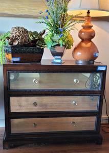 lot 2 image: UTTERMOST DECORATIVE MIRRORED ACCENT TABLE WITH 3 DRAWERS IN STYLE, COLOR, AND CONDITION SHOWN. OTHER ITEMS NOT INCLUDED APPROX. 36 W x 19 D x 31 H.