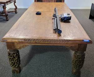 lot 55 image: MUST SEE CUSTOM-MADE HAND CRAFTED HEAVY INTRICATE CARVED WOOD DINING  CONFERENCE TABLE IN STYLE, COLOR, AND CONDITION SHOWN. THIS UNIT WAS MADE BY A DESIGNER IN THE PHILLIPINES. OTHER ITEMS NOT INCLUDED APPROX. 56 W x 140 L x 31 H.