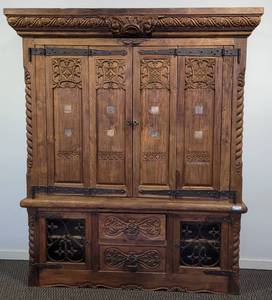 lot 56 image: MUST SEE CUSTOM-MADE HAND CRAFTED HEAVY INTRICATE CARVED WOOD WITH METAL ACCENTS MEDIA CENTER  HUTCH IN STYLE, COLOR, AND CONDITION SHOWN. THIS UNIT WAS MADE BY A DESIGNER IN THE PHILLIPINES. TV NOT INCLUDED APPROX. 73 L x 21 D x 89 H.