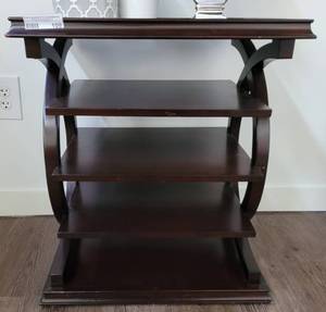 lot 109 image: WOODEN ACCENT TABLE IN STYLE, COLOR, AND CONDITION SHOWN. CONTENTS NOT INCLUDED APPROX. 21 34 W x 16 D x 25 H.