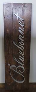 lot 117 image: LARGE WOODEN SIGN WITH BLUEBONNET POLISHED ALUMINUM LOGO AS SHOWN. APPROX. 72 12 L x 22 14 H.