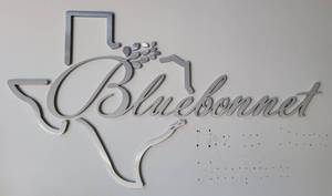 lot 119 image: POLISHED ALUMINUM STYLE BLUEBONNET LOGO AS SHOWN. APPROX. 66 L x 37 H.
