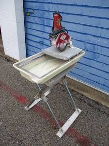 lot 57 image: M.K. #270, 110-V, Title Saw With  Blade, Pan And Work Force Leg Stand.