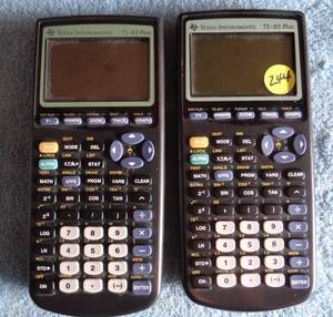 lot 244 image: PAIR TEXAS INSTRUMENTS - TI 83 GRAPHING CALCULATORS