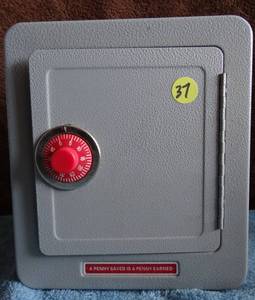 lot 37 image: VINTAGE A Penny Saved is a Penny Earned, Novelty Safe Bank Alarm Bell Works