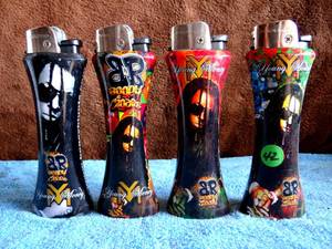 lot 42 image: YOUNG MONEY JUMBO CURVE Refillable LIGHTERS - COLLECTION OF 4 - WITH BOTTLE OPENER
