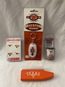 lot 123 image: Texas Longhorn Talking Keychain, Pocket Farkel, Sports Push Pins and a Retractable Brush