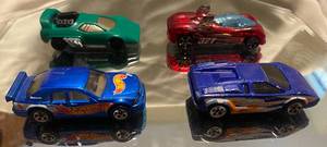 lot 332 image: Hot Wheels 1997 Mercedes C-Class 1999 Blue-Orange Car 1993 Green Car 1995 Power Pipes 321
