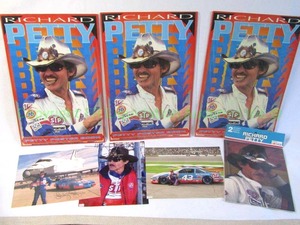 lot 14 image: Assorted Richard Petty memorabilia including Space shuttle print, 3 poster books and more as shown